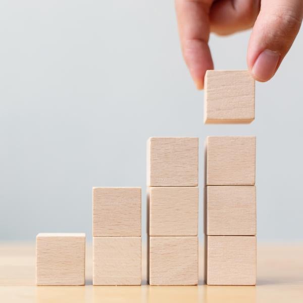 person stacking blocks