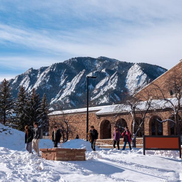campus community members outside of the UMC on a snowy day