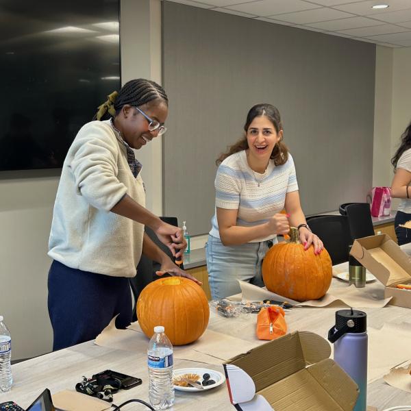 Curci scholars carving pumpkins