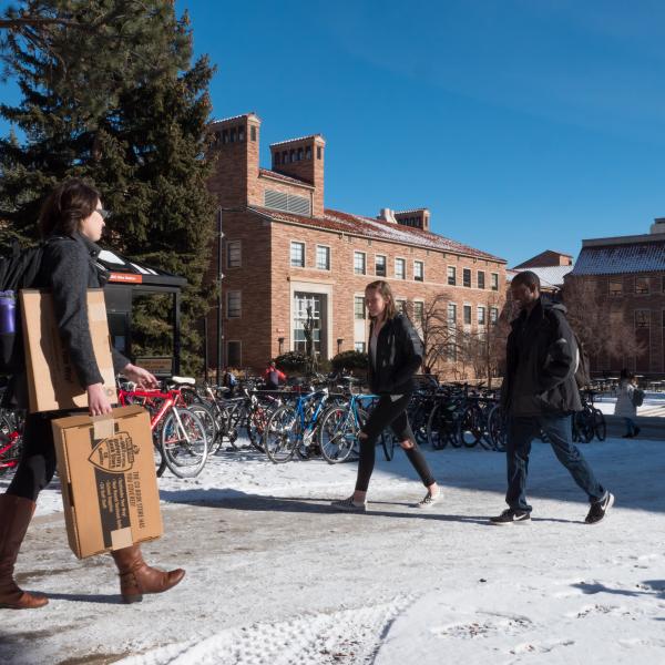 students walking on a snowy campus