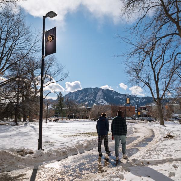 students walking on a snowy campus