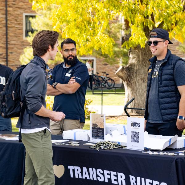 Student visits a Transfer Buffs table at a campus event