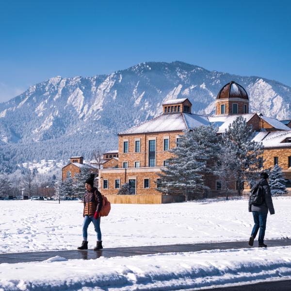 students walking on a snowy campus