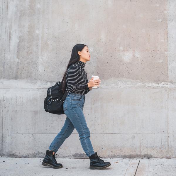 person walking with a cup of coffee in hand