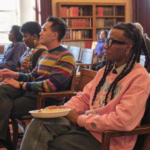 attendees listen at an event on campus