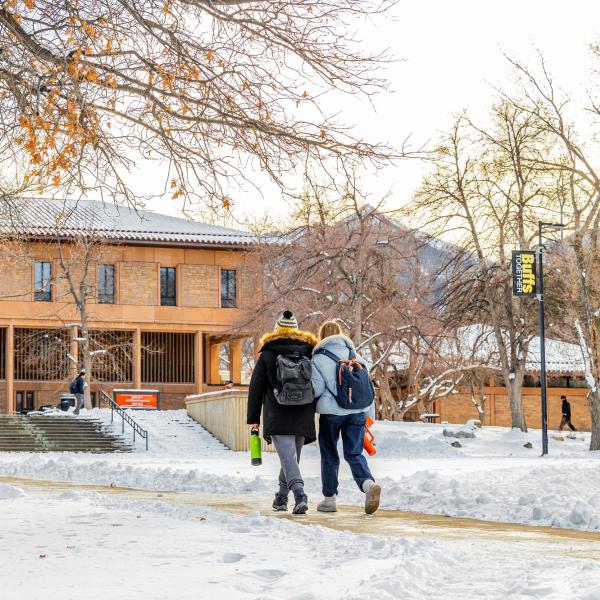 students walking on a snowy campus