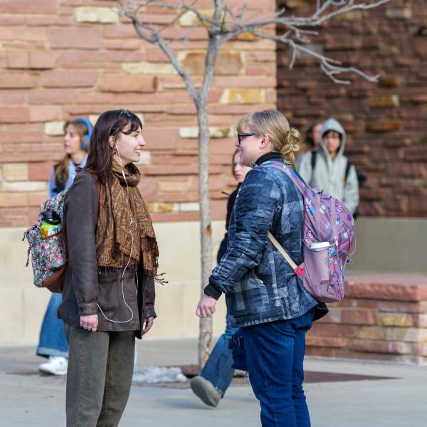 two students talking outside