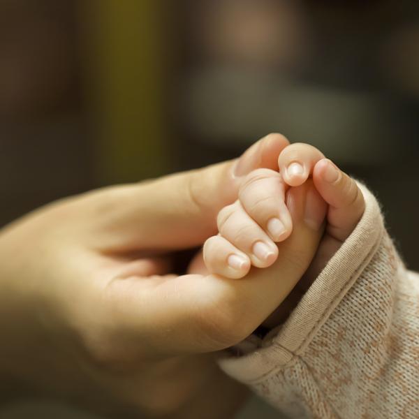 mom holding baby's hand