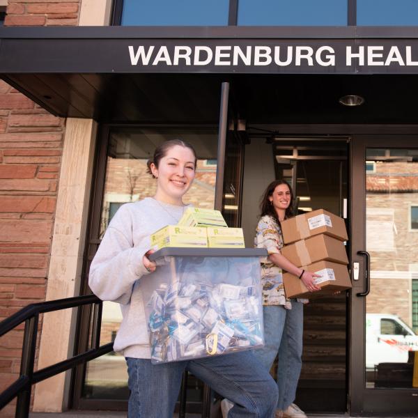 Health Promotion student staff members showcase boxes of naloxone