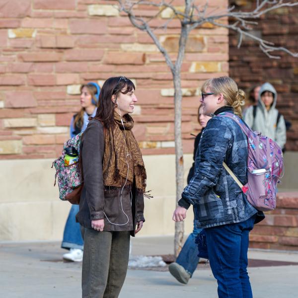 two students talking outside