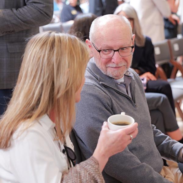 Provost Russell Moore chats with a colleague before the State of the Campus address