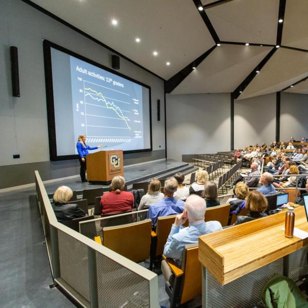 instructor lecturing in large hall