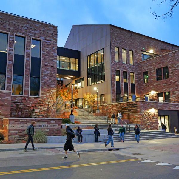 people walking near the CASE building at night