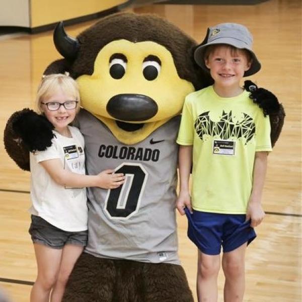 Kids pose for a photo with Chip the buffalo mascot
