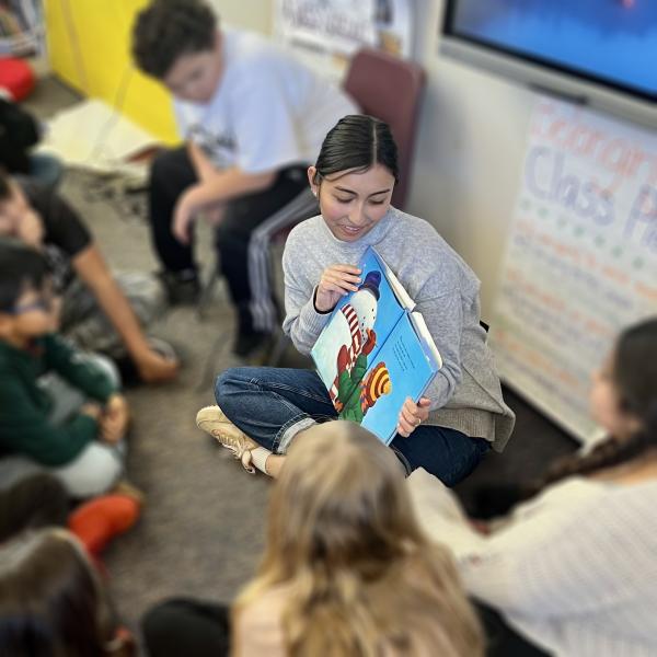 Ashley Kim reading a story in an elementary classroom