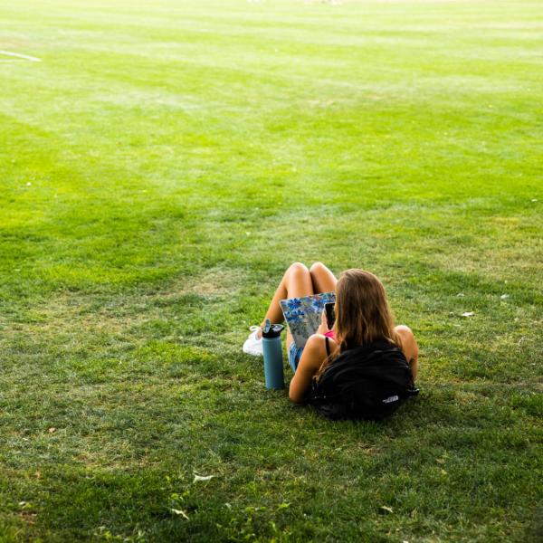 student studying on lawn