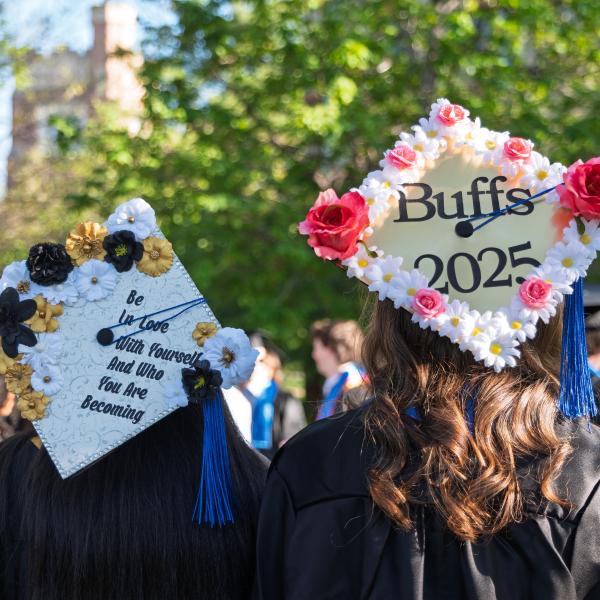 Graduates gather on Norlin Quad before the procession onto Folsom Field