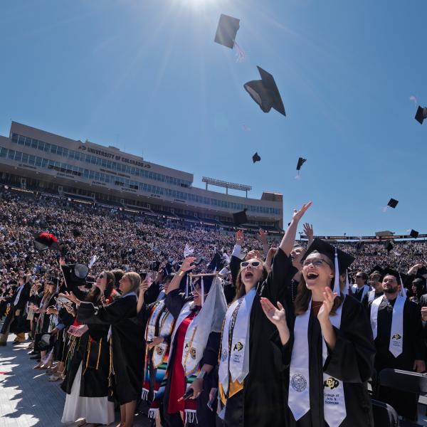 Graduates throw their caps in the air