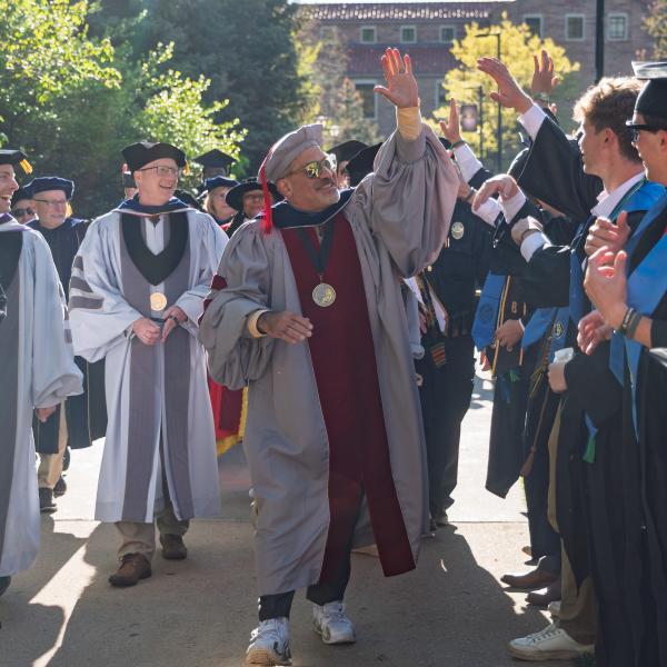 Chancellor Justin Schwartz greets graduates gathered on Norlin Quad