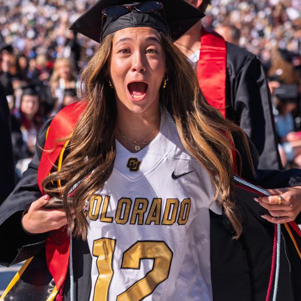 Graduate opening gown to show basketball jersey underneath