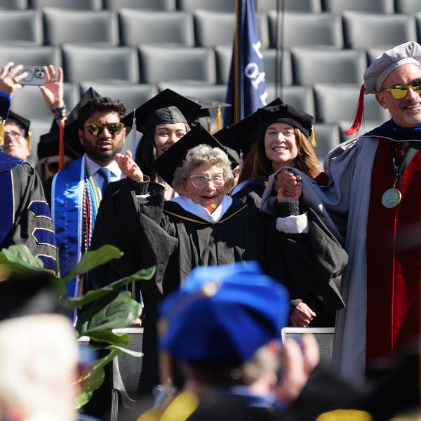 Provost Russ Moore, CU superfan and awardee Peggy Coppom, and Chancellor Justin Schwartz during the commencement ceremony
