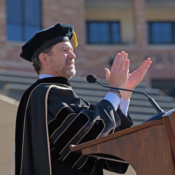 CU President Todd Saliman speaks at the podium