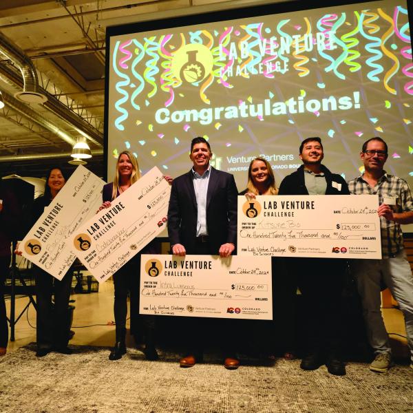 New Venture Challenge winners with prize checks