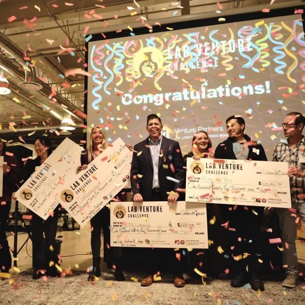 New Venture Challenge winners pose with prize checks