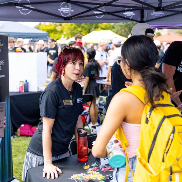 employee tabling at the Be Involved Fair