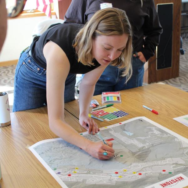 student works with community members