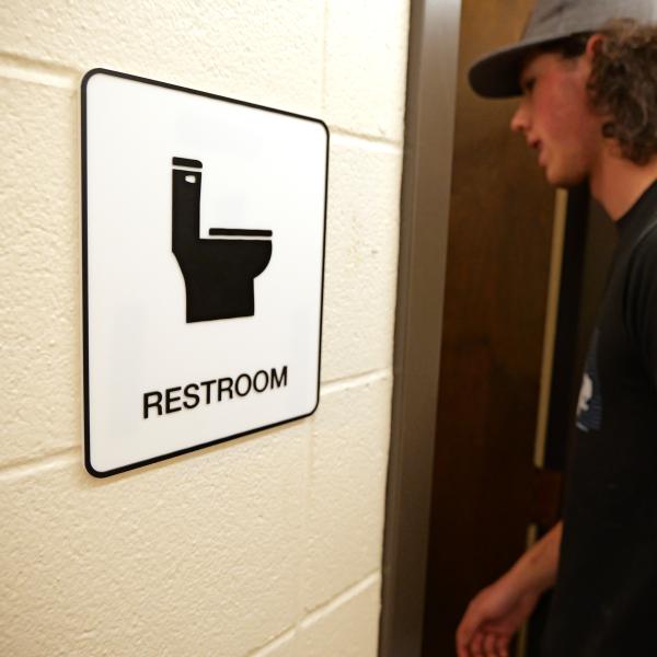 inclusive restroom sign