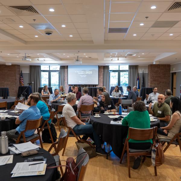 Faculty sit at tables during a session at the New Leaders Orientation