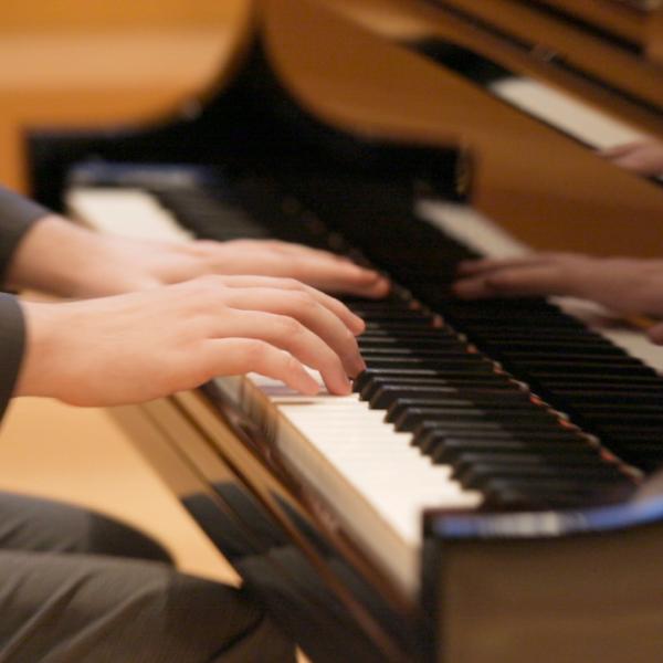 person playing grand piano