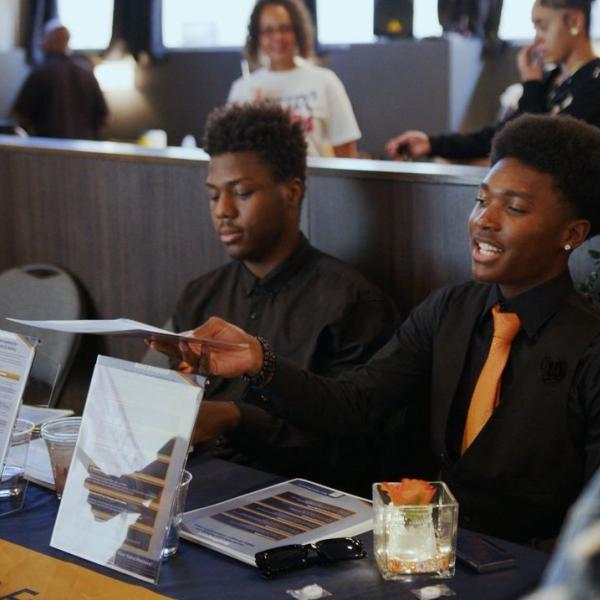 students passing out flyers at an event