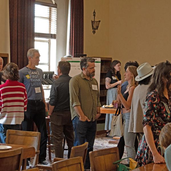Community members mingling at a gathering for the We Are Art Buffs initiative