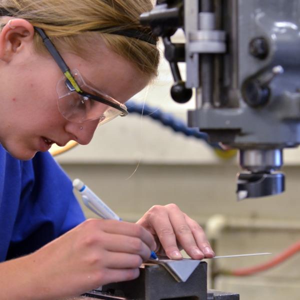 student working in a machine shop