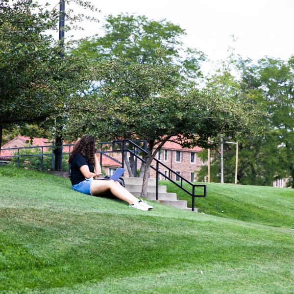 student studying outside on campus