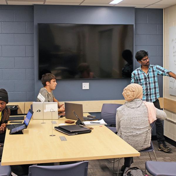 Tutor helps group of students in the new Applied Mathematics Community and Learning Center