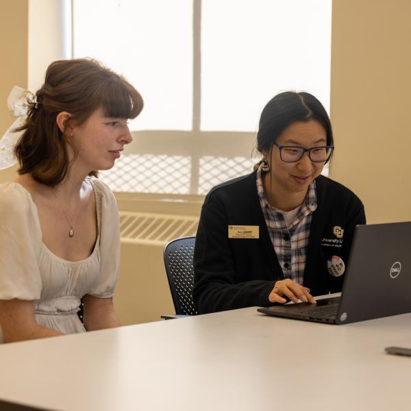 librarian assisting a student in the library