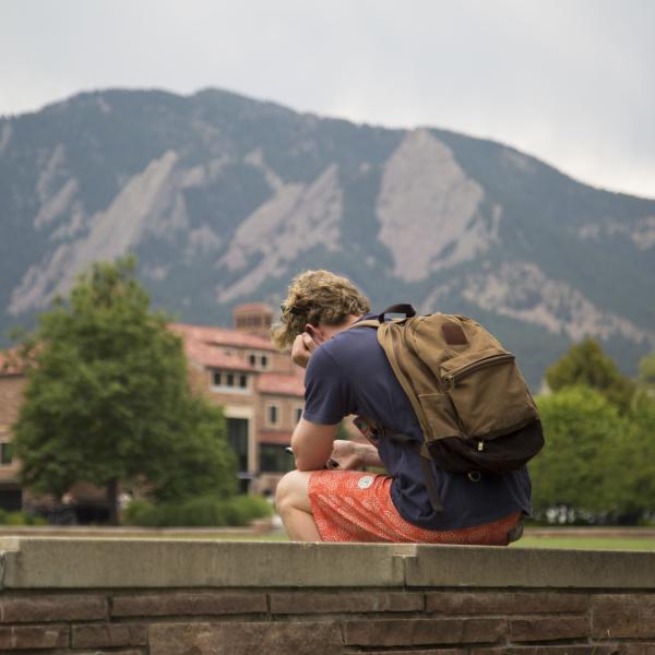 student sitting outside alone