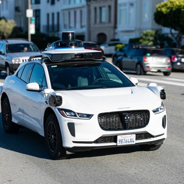 White car with no driver on street