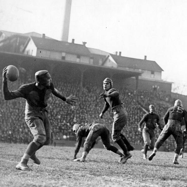 Black and white photos of men playing football in old-fashioned gear