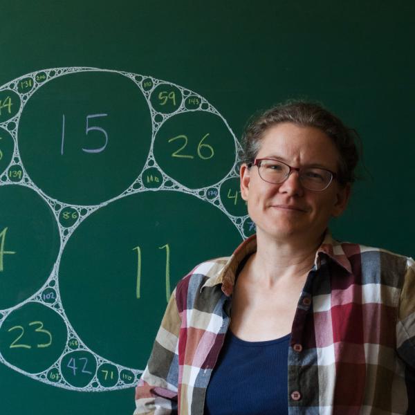 Katherine Stange in front of a chalkboard