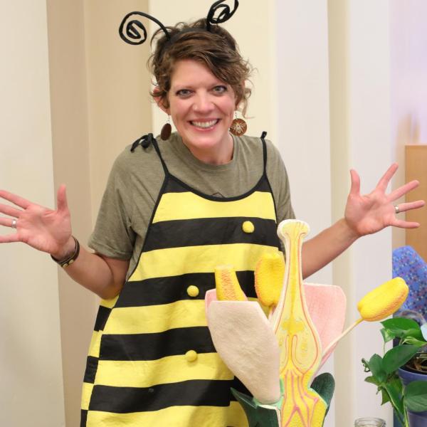 An instructor dressed in a bee costume