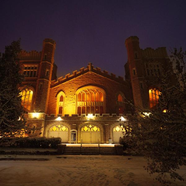 Macky Auditorium at night during snow