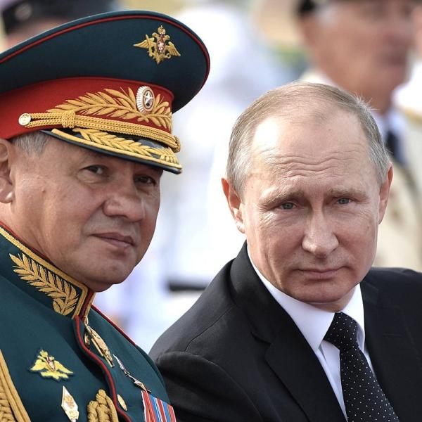 Vladimir Putin sits next to Sergei Shoigu