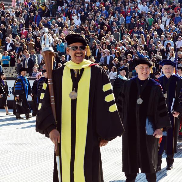 Dean Jim Williams leads a commencement procession.