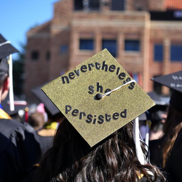 Graduation cap decorated to say "Nevertheless she persisted"