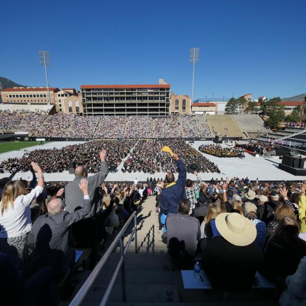 Commencement attendees celebrate in the stands of Folsom Stadium
