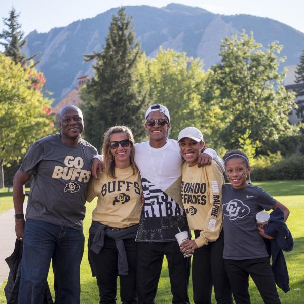 Family poses for photo on campus during annual Family Weekend